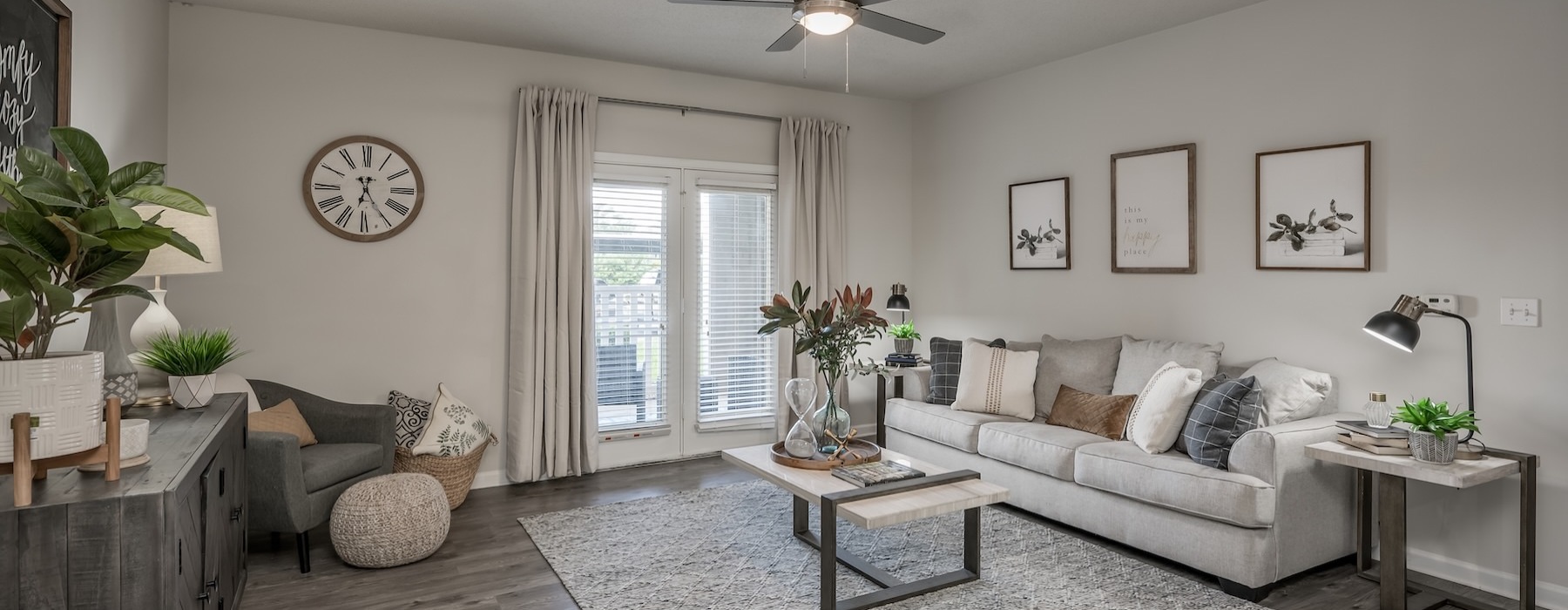 a living room with a couch and a fan